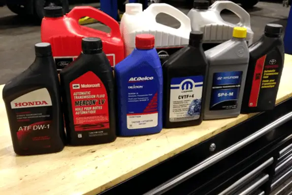 bottles of automatic transmission fluid being stored in a garage