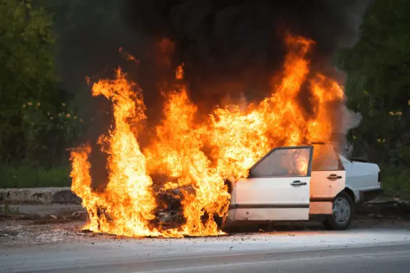 white car covered in flames from burning transmission fluid