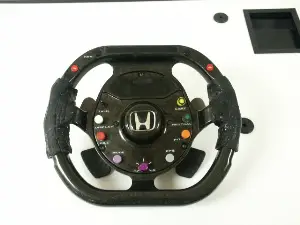 Front side of an F1 car's steering wheel. Along with other controls there are paddle shifters mounted on the backside.