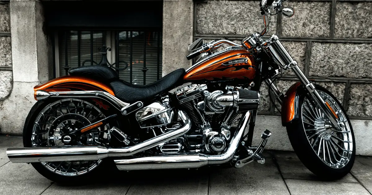 A custom orange Harley Davidson with a Stage 3 kit and an upgraded compensator